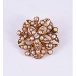 AN EDWARDIAN DIAMOND AND HALF PEARL BROOCH
