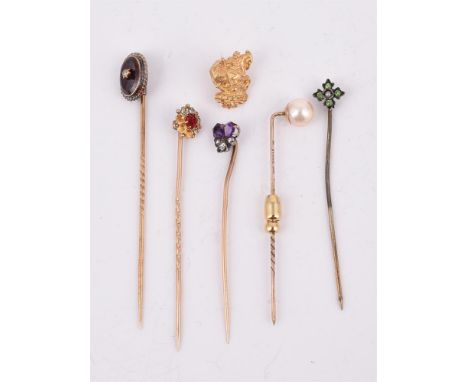 
	
		A GROUP OF STICKPINS
		Comprising an amethyst and diamond pansy stickpin, French poincon; an oval garnet stickpin with a