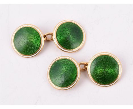 
	
		A PAIR OF EARLY 20TH CENTURY GOLD, GREEN AND WHITE ENAMEL CUFFLINKS 
		The circular panels with engine turned decoration