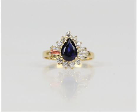 Synthetic sapphire and cubic zirconia dress ring, central pear cut sapphire weighing an estimated 1.09 carats, with a surroun