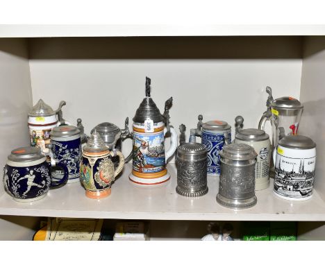 A COLLECTION OF TWELVE METAL, GLASS AND CERAMIC BEER STEINS, all second half 20th Century, includes commemorative, sporting t