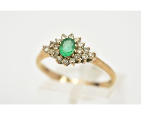 A 9CT GOLD EMERALD AND DIAMOND CLUSTER RING, designed with a central oval cut emerald, within a round brilliant cut diamond s