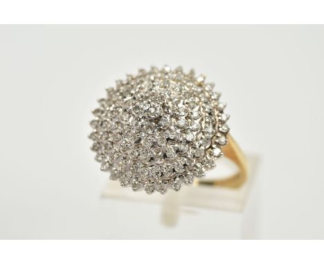 A 9CT GOLD DIAMOND CLUSTER RING, the tiered cluster ring set with single cut diamonds, to the tapered shoulders and plain pol