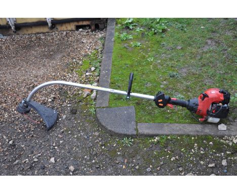 AN UNBRANDED PETROL STRIMMER (engine pulls freely but hasn't been started)