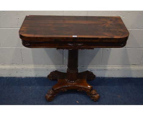 A 20TH CENTURY REGENCY STYLE ROSEWOOD CARD TABLE, rounded front corners with a fold over top, on a cylindrical and acanthus p