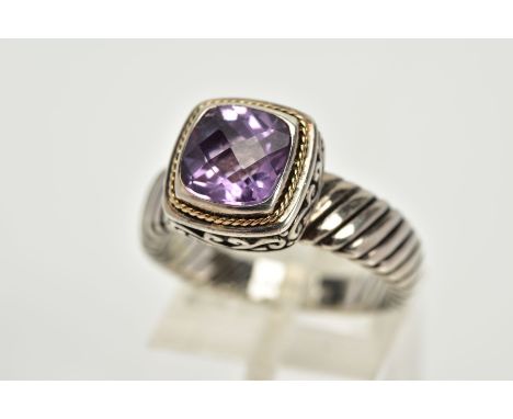A SILVER AMETHYST RING, designed with a cushion cut amethyst within a collet mount with a rope twist surround, in a raised sc