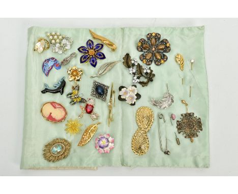 A CUSHION SLEEVE WITH COSTUME BROOCHES AND STICK PINS, to include twenty five brooches of various designs and forms, such as 