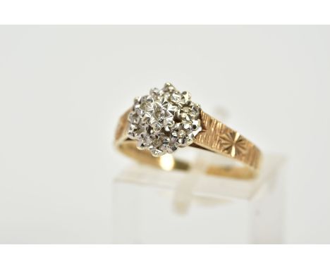 A 9CT GOLD DIAMOND CLUSTER RING, the raised cluster with illusion set single cut diamonds, with textured engraved shoulders, 