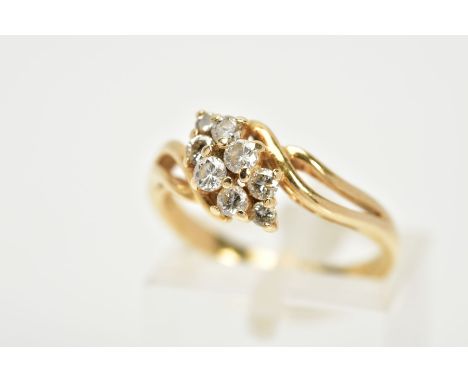 A YELLOW METAL DIAMOND RING, the asymmetrical lozenge shape set with eight round brilliant cut diamonds, total estimated diam