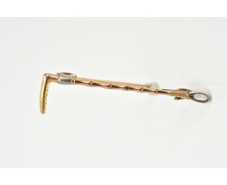 A YELLOW METAL BAR BROOCH, in the form of a riding crop, length 50mm, approximate gross weight 4.3 grams (condition:- overall