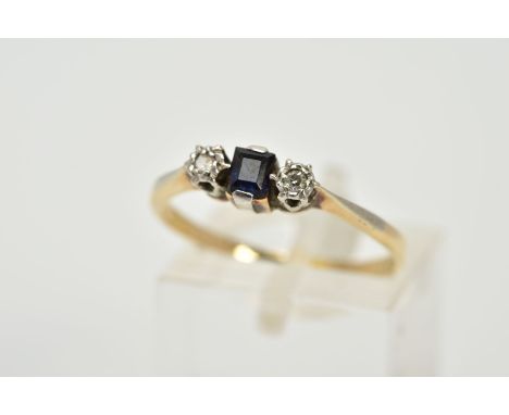 A THREE STONE SAPPHIRE AND DIAMOND RING, the yellow metal ring set with a central square cut sapphire flanked with illusion s