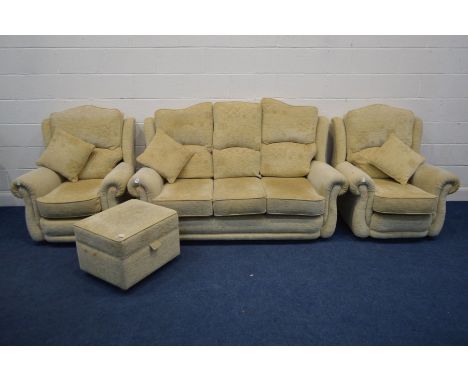 A BEIGE UPHOLSTERED FOUR PIECE LOUNGE SUITE, comprising a three seater settee, pair of armchairs and a pouffe (4)