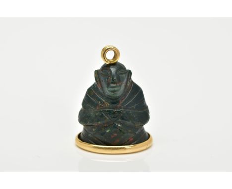 AN 18CT GOLD MOUNTED CARVED BLOODSTONE PENDANT, the carved bloodstone in the form of a buddha, mounted on a gold oval base, w