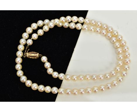 A CULTURED PEARL STRAND NECKLACE, each circular pearl approximately 5.0mm, on a white cord, fitted with a 9ct gold fish hook 