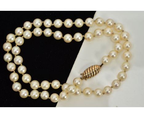 A CULTURED PEARL NECKLACE, each circular pearl measuring approximately 7.0mm, on a white cord fitted with a gold fish hook cl