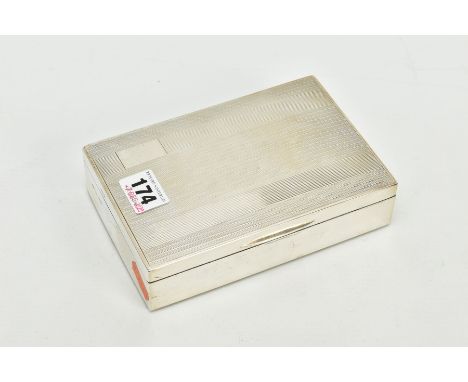 A STERLING SILVER CIGARETTE BOX, of engine turn design and vacant cartouche to the lid, opens to reveal two compartments, wit