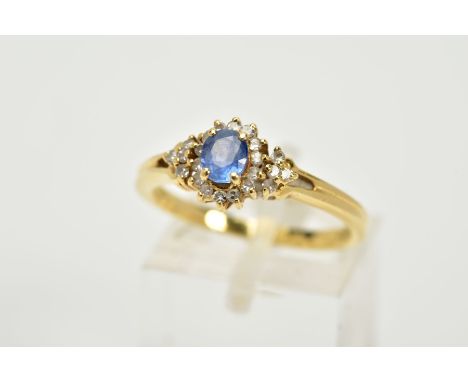 AN 18CT GOLD SAPPHIRE AND DIAMOND CLUSTER RING, designed with a central oval cut blue sapphire within a single cut diamond su