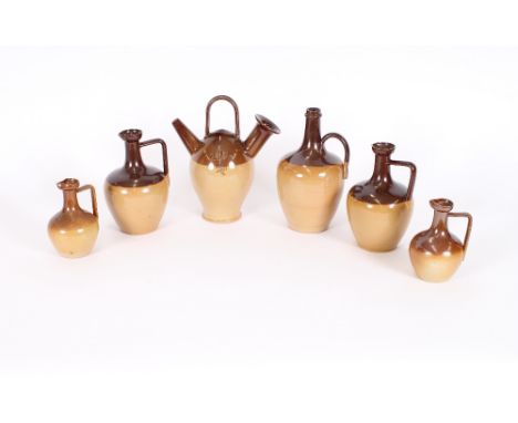 A Doulton Lambeth stoneware Sarum kettle, 26.5cm high; a pair of Doulton Lambeth baluster ewers, 21cm high; and a pair of sim