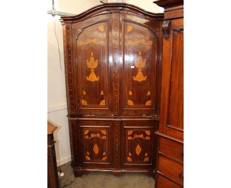 A late 18th Century mahogany and Dutch marquetry double standing corner cupboard, the interior shelves enclosed by two pairs 