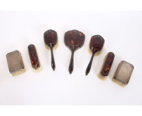 A part faux tortoiseshell and silver mounted dressing table set, Birmingham 1930; and a pair of Art Deco design silver hair b