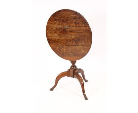 An antique oak circular snap top occasional table, raised on a turned baluster column and tripod base, 69cm dia. 