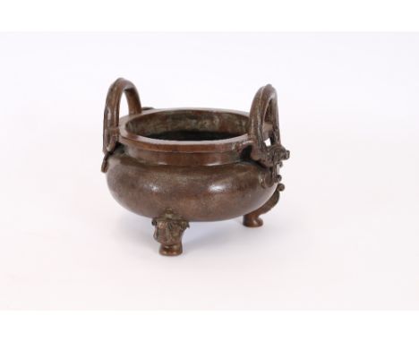 A large Chinese bronze censor, having coiled dragon handles and mythological beast head feet, 33cm dia. overall x 26cm high 