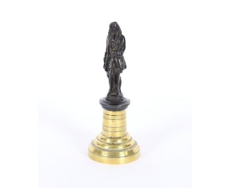 A late 19th Century bronze figure of Isaac Newton, raised on circular stepped brass plinth, 17cm high overall 