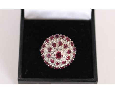 A ruby and diamond cluster ring, set to an 18ct gold mount 