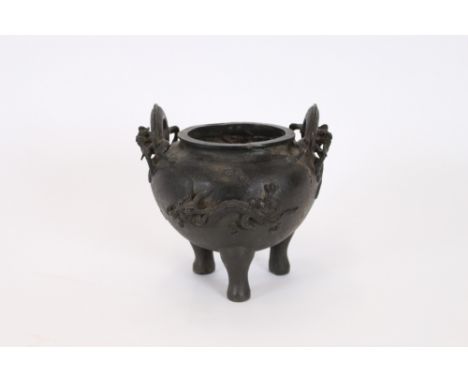 An early Chinese bronze censer of bulbous form, having dragon applied decoration to the body on tripod feet, six character Mi