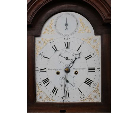 A George III oak long cased clock, by George Suggate of Halesworth, having floral decorated painted arch dial supporting an e