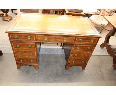 An Edwardian mahogany and satin wood cross banded pedestal writing desk, the leather inset box top fitted three drawers with 