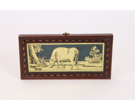 A 19th Century reverse print on glass, depicting a bull in country landscape within an inlaid frame, 10cm 20cm overall