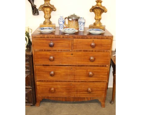A 19th Century mahogany chest, fitted two short and three long drawers, raised on a shaped apron and bracket feet, 98cm wide