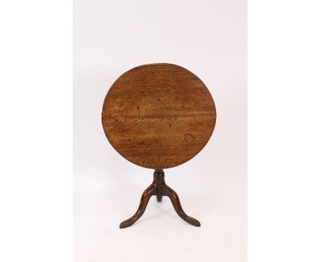 An antique oak circular snap top occasional table, raised on a baluster turned column and tripod base, 65cm dia. 