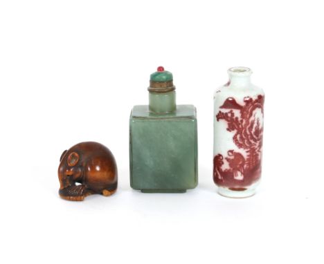 A Chinese green hardstone snuff bottle; a porcelain similar with decoration of figures in a landscape; and a carved wooden Ne