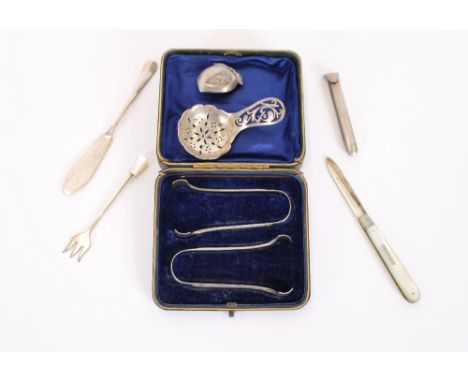 Two pairs of cased silver tongs, London 1897; a silver caddy spoon, Birmingham 1920; a silver bladed and mother of pearl penk