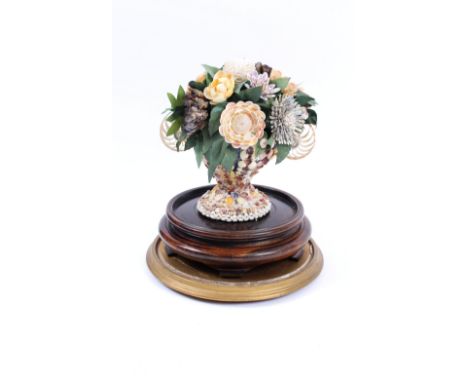 A Victorian dried flower and shell table arrangement, under a glass dome, raised on a mahogany stand and gilt plinth, 44cm hi