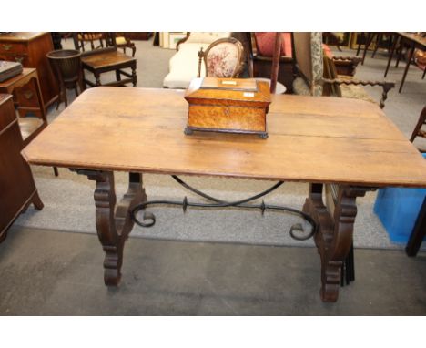 An Antique continental fruitwood stretcher table, raised on shaped end supports and united by an iron cross-stretcher, 150cm 