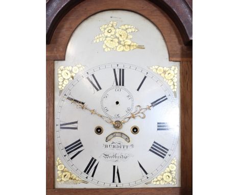 An 18th Century oak long case clock, the arched hood surmounted by brass orb finials, floral painted dial, inscribed "Burditt