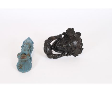 An antique cast iron door knocker, in the form of a leaf decorated mask head; and another of leaf and lanyard form (2) 