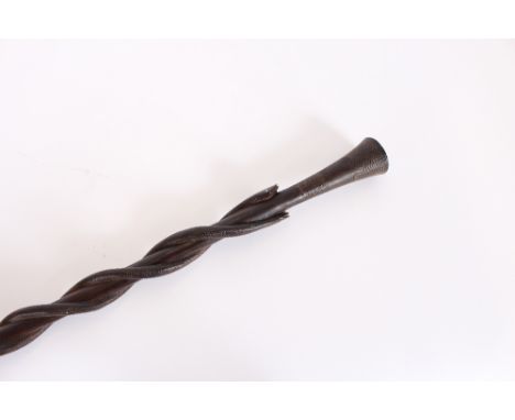 An African carved hardwood walking stick, with entwined snake decoration, 104cm long