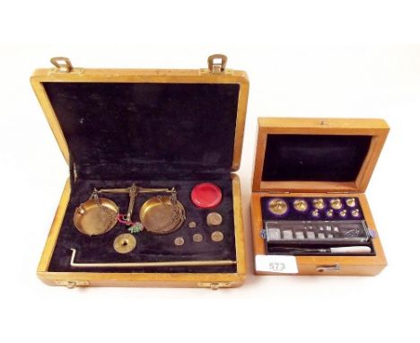 A set of gold weights boxed and a set of scales and weights boxed 