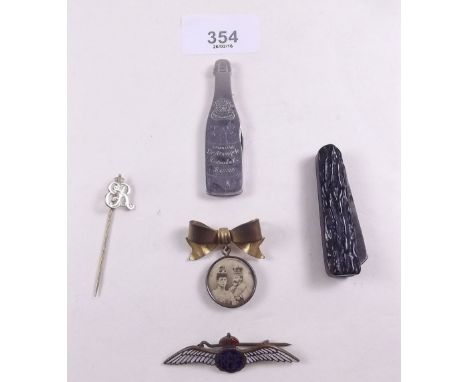 A RAF enamel wings badge and a Royal commemorative ribbon brooch, Edward VII stick pin and a novelty advertising champagne pe