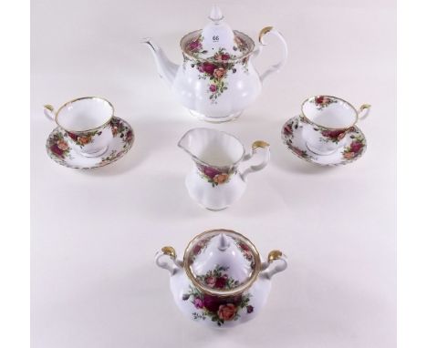 A Royal Albert Country Roses tea service comprising: teapot, six cups and saucers, milk, sugar, two cake plates and five tea 