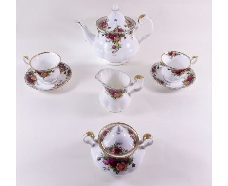 A Royal Albert Country Roses tea service comprising: teapot, six cups and saucers, milk, sugar, two cake plates and five tea 