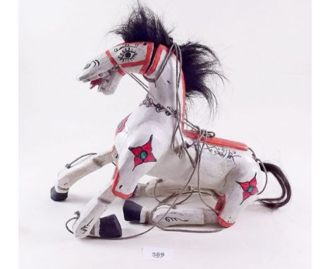 A painted wooden horse puppet 