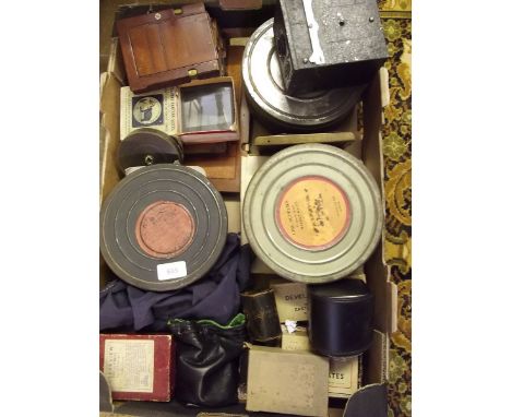 A box of camera equipment, film reels, lantern slides, photo plates etc.