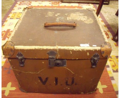 A square vintage hat box with leather handle and corners