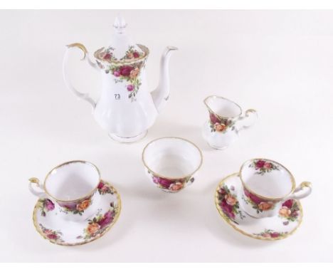 A Royal Albert Country Roses coffee set comprising: coffee pots, six cups and saucers, two sugar and milk jug 