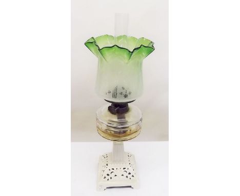 A Victorian oil lamp with green frilled and etched shade